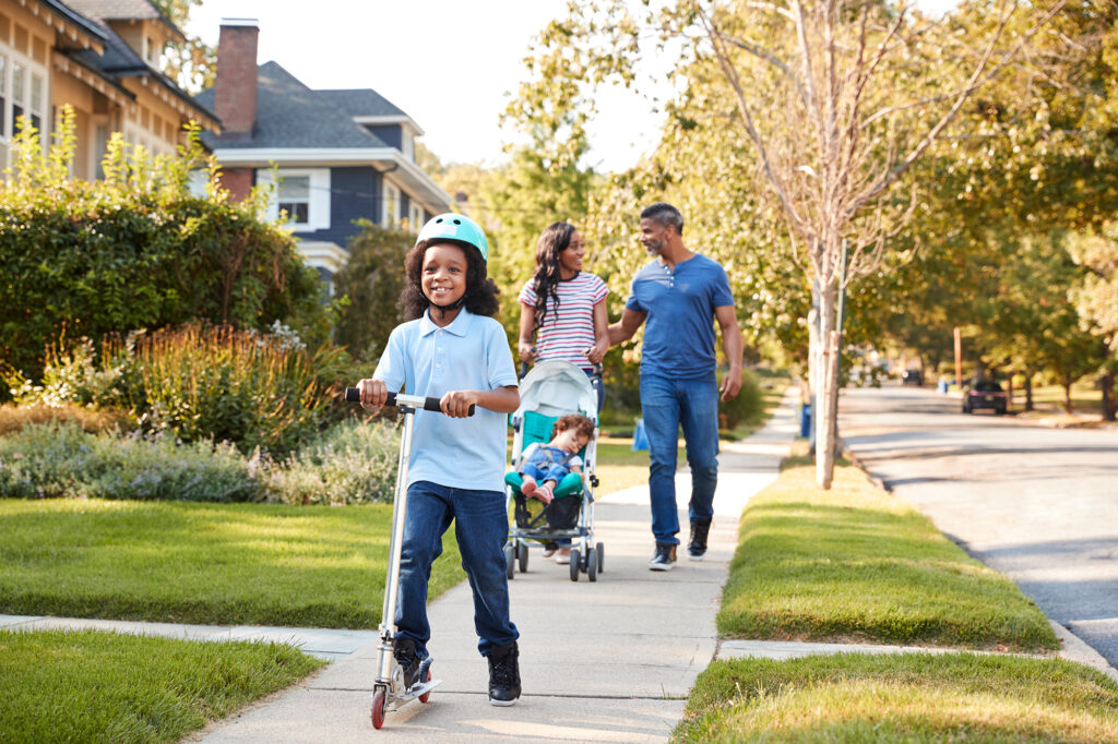 Family on the sidewalk of their new house